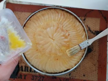 Sortir la tarte fine aux poires et la badigeonner de beurre à nouveau